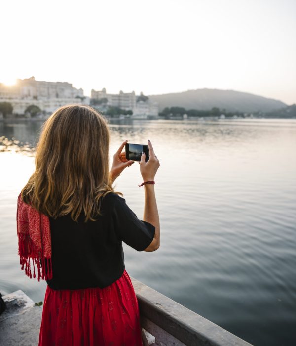 Western woman capturing the view of Udaipur city, India
